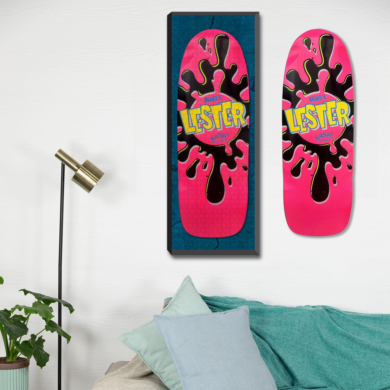 The Brand-X Lester Green and blue skateboard graphic at 10"x30", 500 pieces hanging on a wall next to a Lester Skateboard.