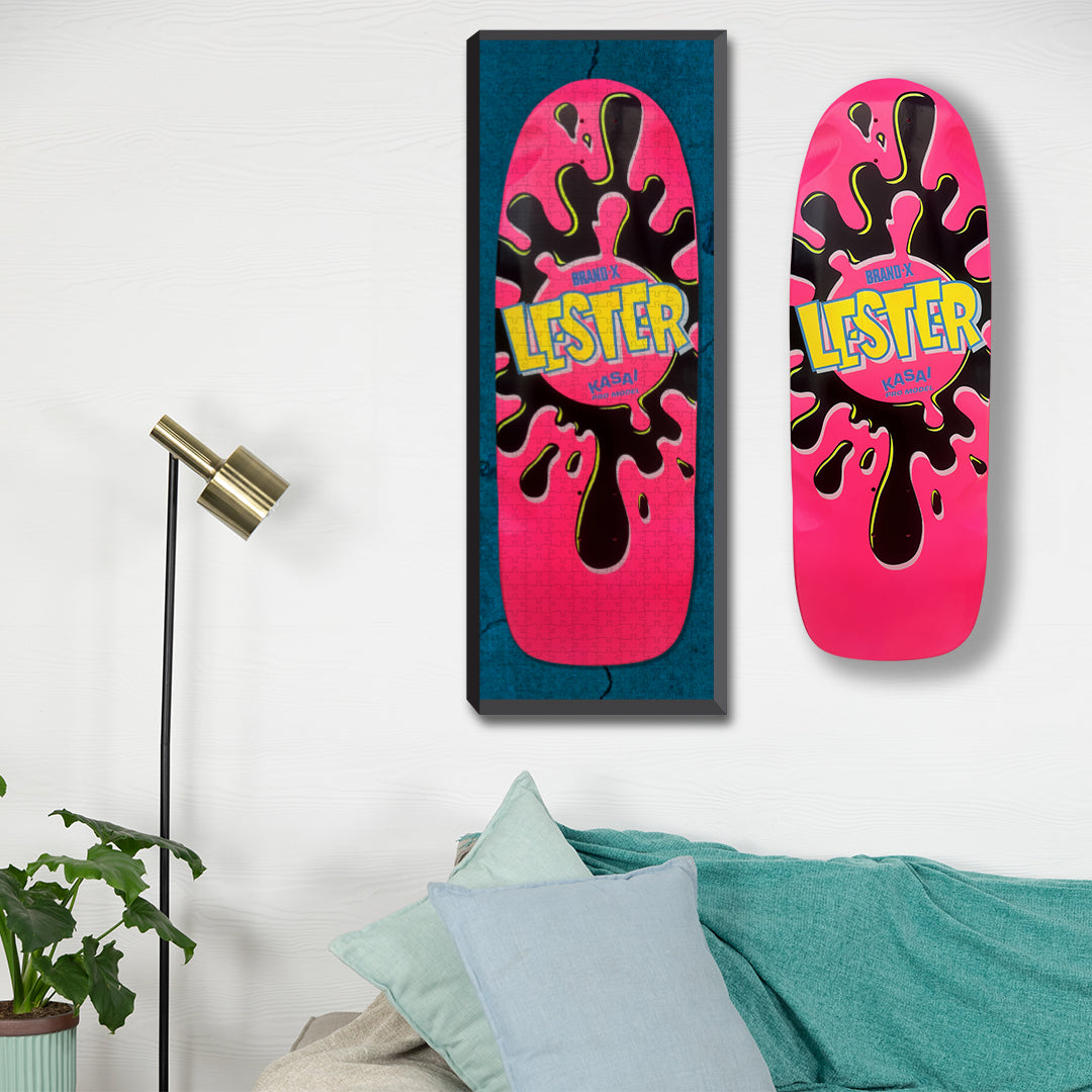 Picture of a Pink Lester Sk8zzle framed  on a skateboard collector wall next to an original Brand-X Pink Lester Skateboard. 