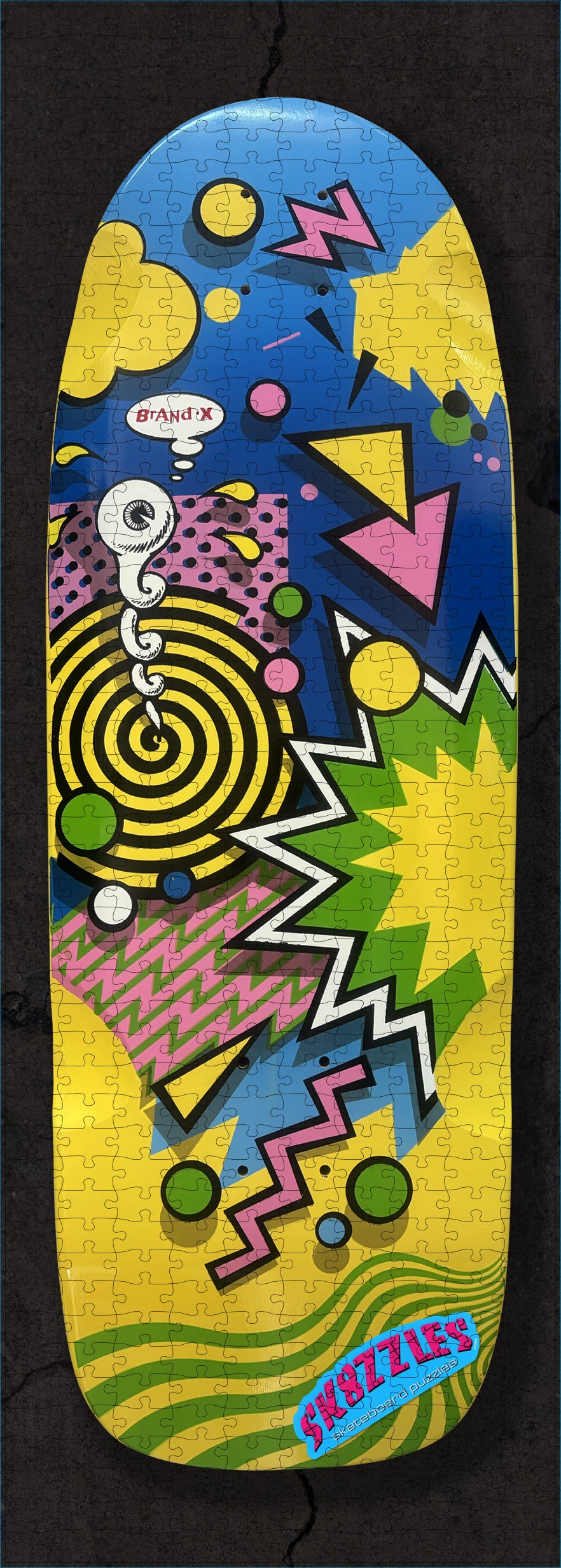 The Brand-X Weirdo Yellow Sk8zzle Skateboard puzzle is a 12"x34" full-sized puzzle of of the Brand-X Weirdo graphic.&nbsp;